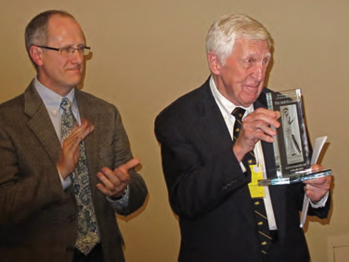 Stroud accepts the Aristeia Award from ASCSA Alumni/ae Association President Bill Hutton in 2013.